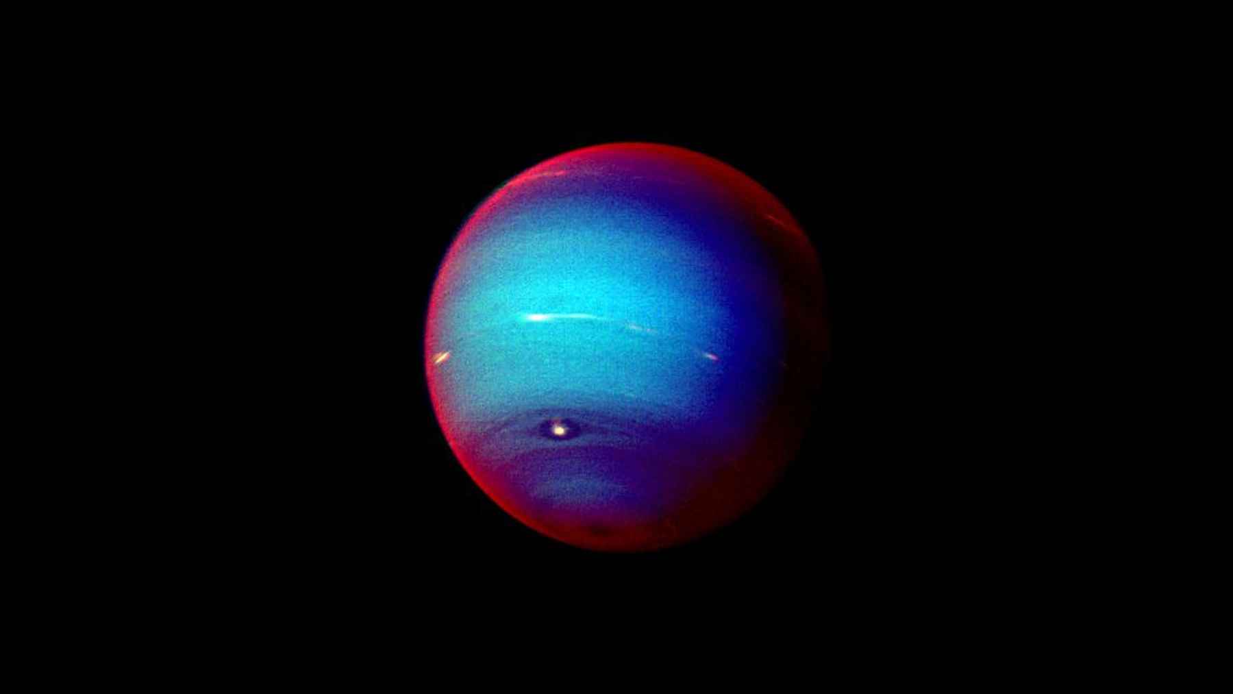 False-color image of Neptune against black space, illustrating new research on the planet’s unusual magnetic field