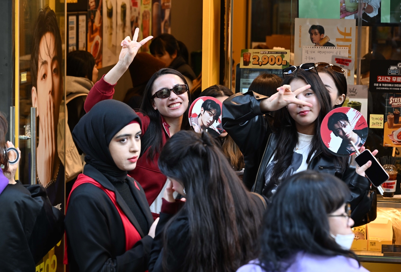 Foreign fans line up at a coffee shop advertised by V, a member of BTS, at Gwanghwamun Square in Seoul, ahead of the group’s free comeback show, “BTS The Comeback Live: Arirang.” (The Korea Herald/ Lee Sang-sub)