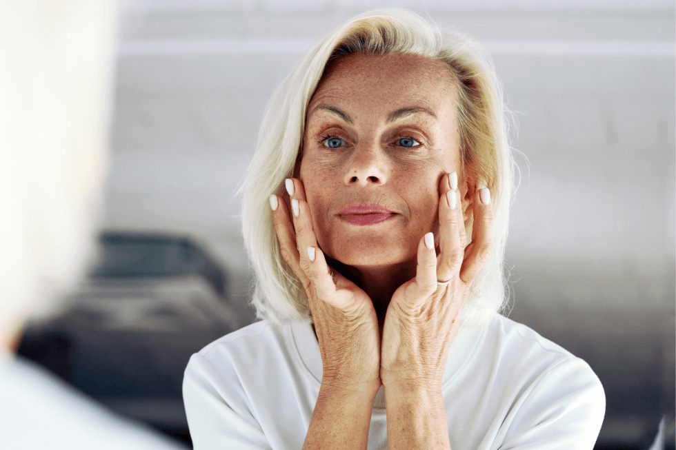Older woman touching face