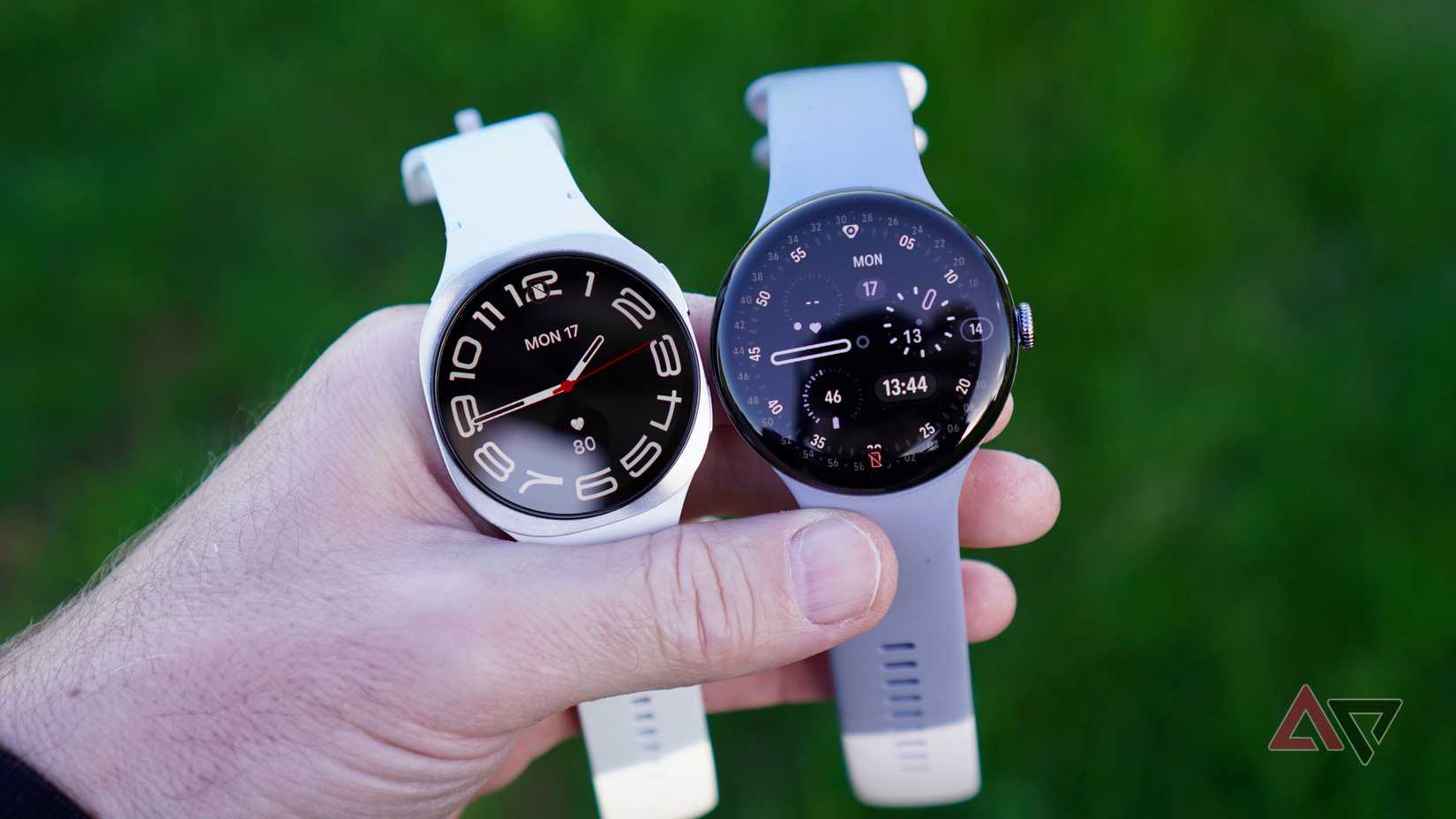 A person holding the Google Pixel Watch 4 and Samsung Galaxy Watch 8