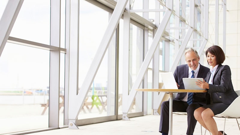 3 people looking at a tablet