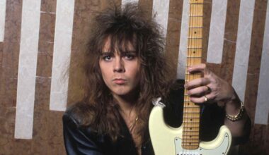 Ynwgie Malmsteen holding a guitar