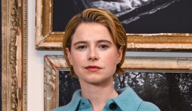 Jessie Buckley wearing barrel leg jeans and teal cardigan