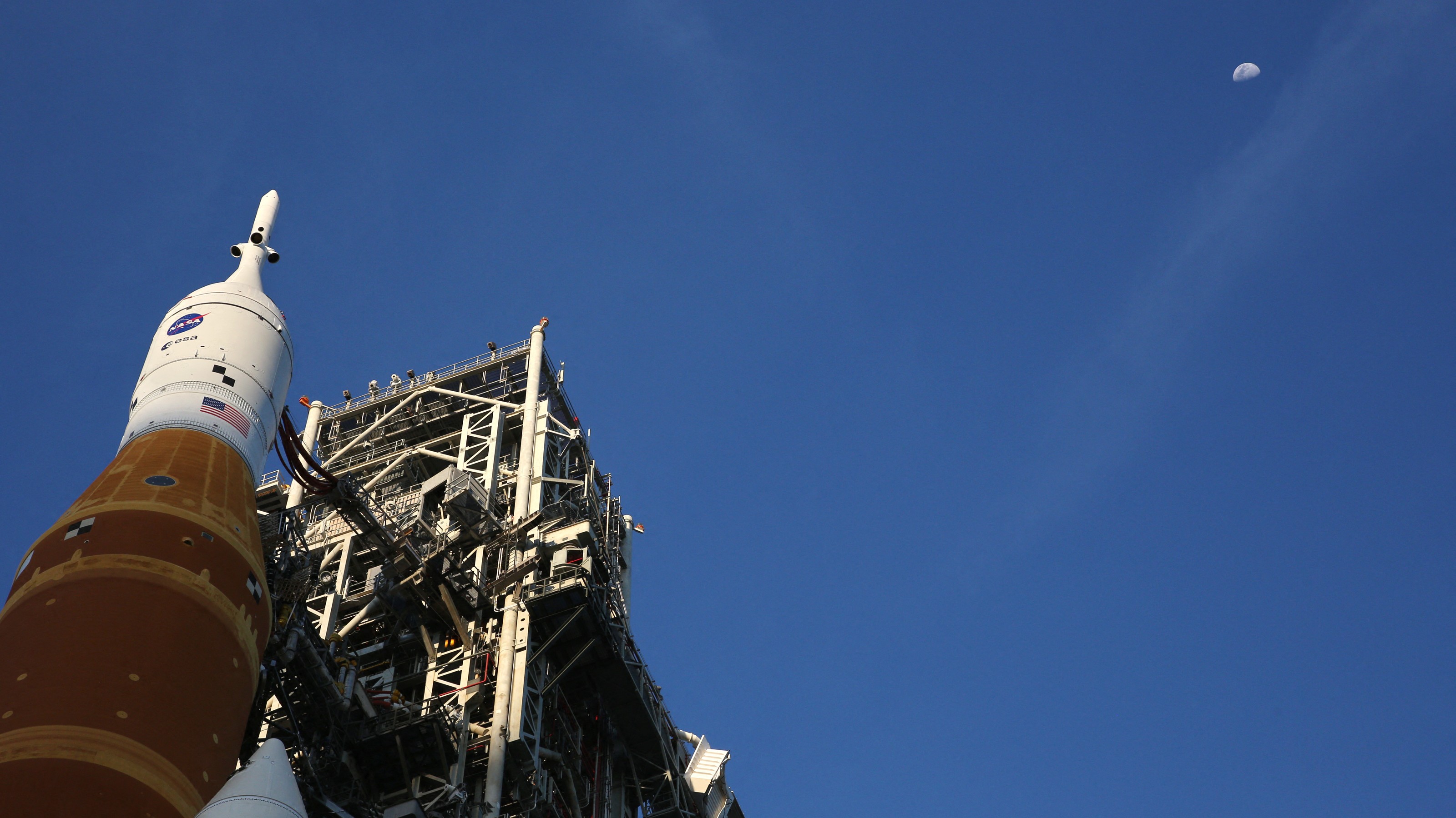 The Orion spacecraft points at the moon from its perch atop the Artemis II Space Launch System (SLS) rocket as it was rolled back to the Vehicle Assembly Building on February 25, 2026.