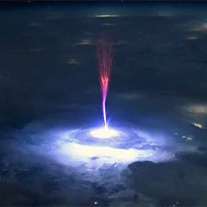 Red sprites like this one are called TLEs or Transient Luminous Events. They happen above the clouds and are triggered by intense electrical activity in the thunderstorms below. Astronauts have a great view above the clouds, so scientists can use these types of pictures to better understand the formation, characteristics, and relationship of TLEs to thunderstorms. Credit: NASA/Nichole Ayers