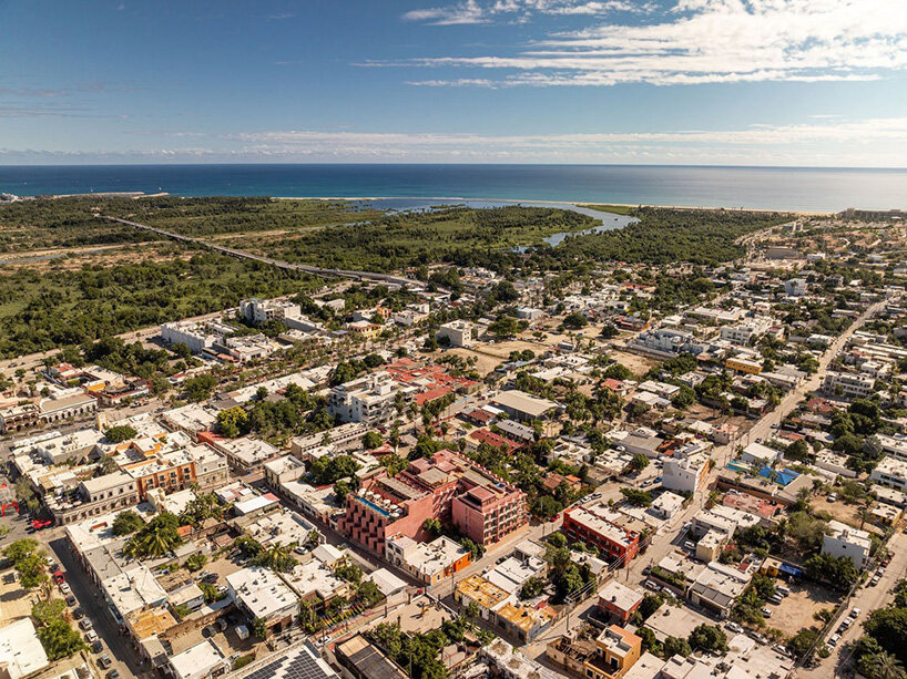 red-toned stucco surfaces form layered facade for boutique hotel by RA! in mexico - 11