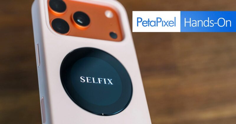 Close-up of a smartphone with three rear cameras and an attached round device labeled "SELFIX," with the Petapixel Hands-On logo in the background.