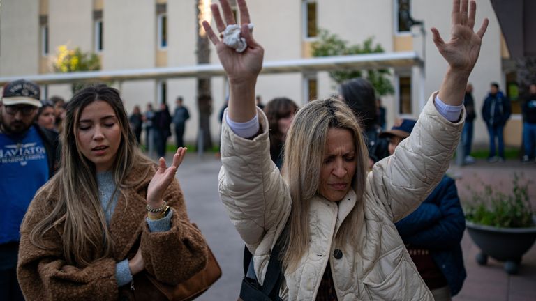 Two women pray at the entrance of the Sant Camil hospital ahead of Noelia's euthanasia. Pic: AP