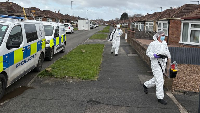 Forensics officers at the scene in Kennerleigh Avenue. Pic: PA