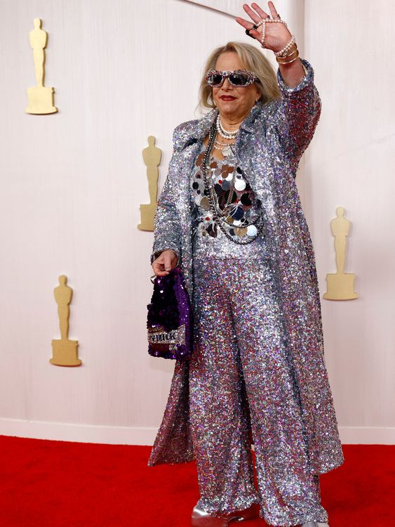 Composer Laura Karpman's 2024 outfit was described by commentators as 'glittering chaos'. She gave out chocolate bars from her sequined Dairy Milk bag. I, for one, am here for it. Pic. Reuters