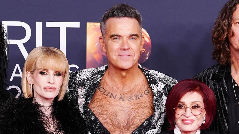 A shirtless Robbie Williams (C) Kelly Osbourne (L) and Sharon Osbourne (R). Pic: PA
