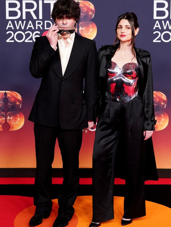 The Charlatans star Tim Burgess (L) faces the glare of the photographers with some sunnies. Pic: PA