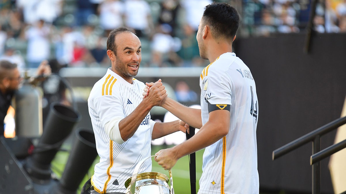 Landon Donovan greets Maya Yoshida