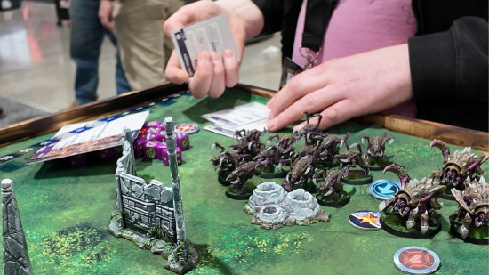 A player moving cards in the Starcraft Tabletop Miniatures Game