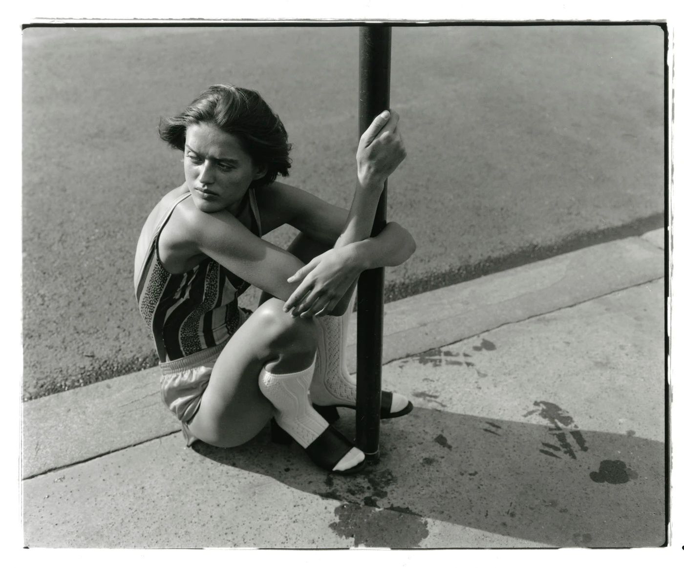 Image may contain Clothing Shorts Face Head Person Photography Portrait Body Part Finger Hand Adult and Sitting