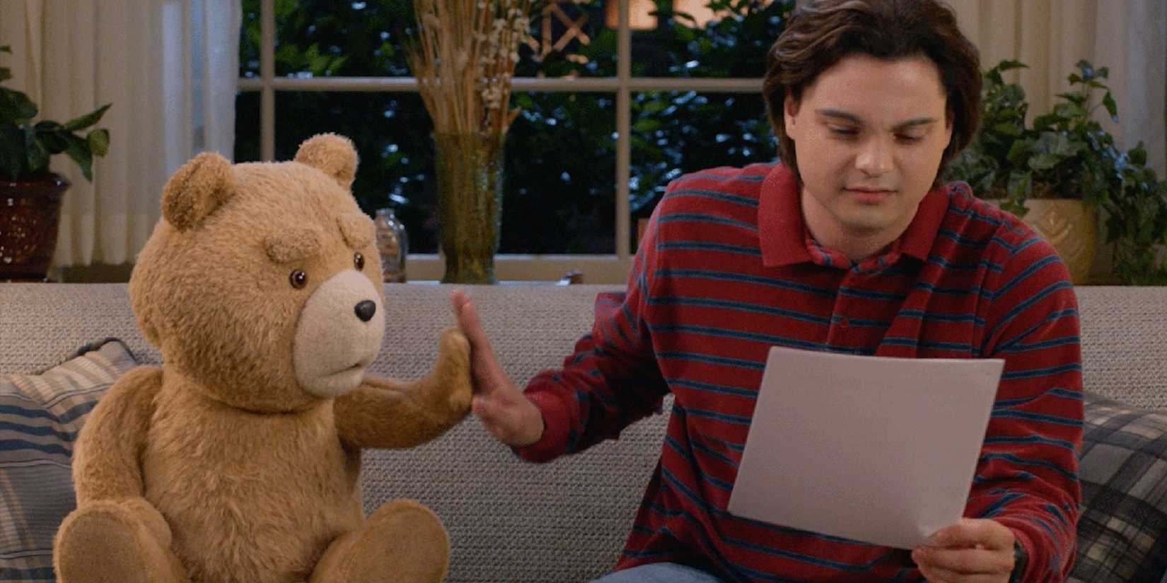 Ted and John looking at a piece of paper in Ted season 2