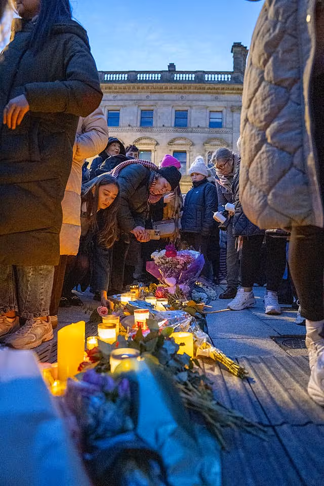 People attend a vigil for Amy Doherty at the Guildhall in Londonderry