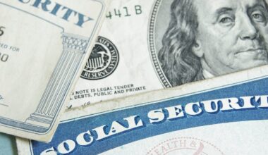 Two Social Security cards lay atop U.S. currency.