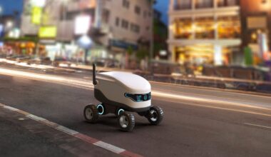 An autonomous delivery robot driving along the sidewalk.
