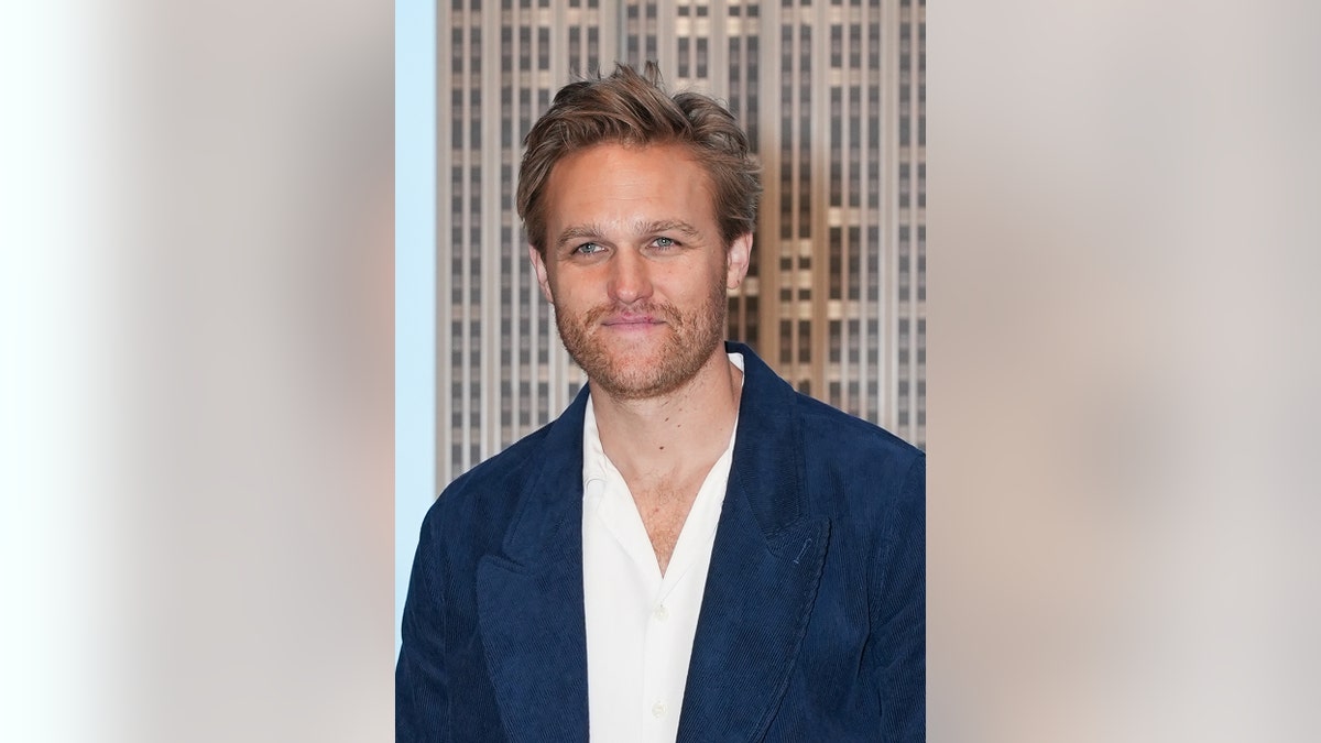 Close-up of Wyatt Russell in a blue blazer and white shirt.