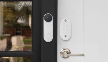 Yale's smart lock on a white door beside a white Nest video doorbell.