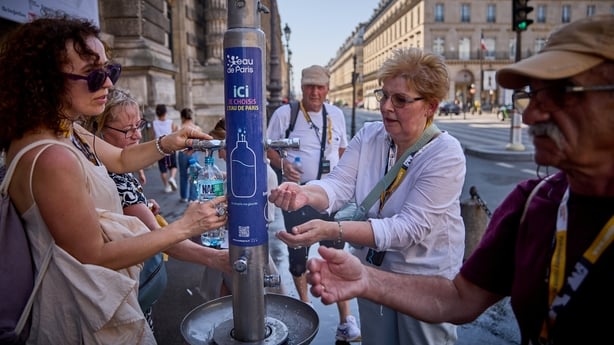 PARIS, FRANCE - JULY 01: People use a public fountain on the Rue de Rivoli to cool off from the heat of the day as Paris experiences temperatures of up to 44°C on July 01, 2025 in Paris, France. The French weather agency Météo France has placed Paris and 15 other districts on the highest alert for h