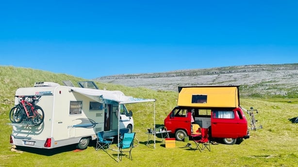 Two campervans parked up at a site