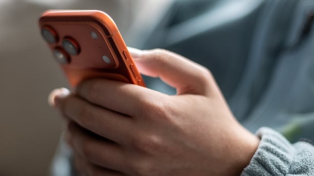 BATH, UNITED KINGDOM - DECEMBER 13: In this photo illustration a 15-year-old boy looks at a iPhone screen displaying various social media apps on December 13, 2025 in Bath, England. Recently Australia has passed a law banning children under 16 from having social media accounts and social media platf