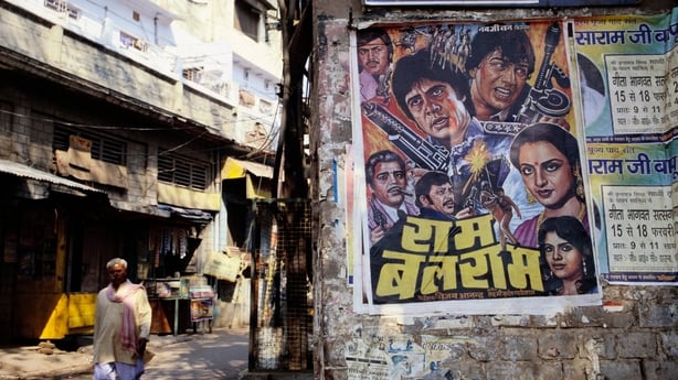 A poster advertises a Bollywood film at a bazaar near the Jami Masjid in Agra