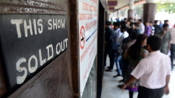 A 'sold out' sign is displayed for a screening of the popular Bollywood Hindi film Dilwale Dulhania Le Jayenge (The Brave-hearted Will Take the Bride Away) at the Maratha Mandir cinema in Mumbai on 12 December, 2014. Photo: INDRANIL MUKHERJEE/AFP via Getty Images)