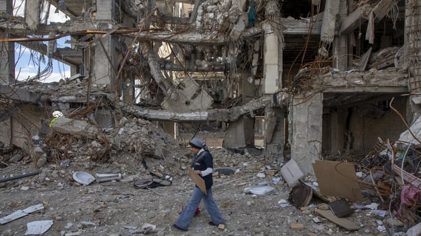 TEHRAN, IRAN - APRIL 6: A woman walks among buildings destroyed in a joint attack by Israel and the United States on April 6, 2026, in Tehran, Iran. The United States and Israel continue their joint attack on Iran that began on February 28. Iran retaliated by firing waves of missiles and drones at I