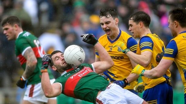 9 April 2023; Aidan O'Shea of Mayo in falls back against Conor Hussey and David Murray of Roscommon during the Connacht GAA Football Senior Championship Quarter-Final match between Mayo and Roscommon at Hastings Insurance MacHale Park in Castlebar, Mayo. Photo by Ray Ryan/Sportsfile