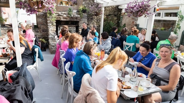 People eat at picnic tables