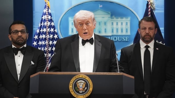 US President Donald Trump speaks during a press conference while flanked by FBI Director Kash Patel and Secretary of Homeland Security Markwayne Mullin in the Briefing Room of the White House.