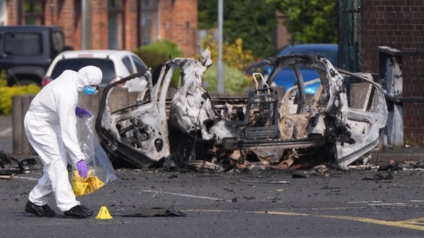 Forensic investigators at the scene in Dunmurry in Northern Ireland after a car explosion outside a police station. Homes in the area, which is on the outskirts of Belfast, have been evacuated and members of the public have been advised to avoid the scene. The explosive device in the car that detona