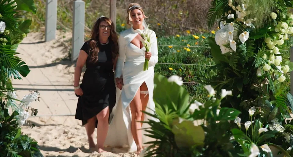 Gia donned a slim, fitted dress by European designers Milla Nova, which featured a plunging neckline and thigh-high split which exposed her garter. Photo: Nine 