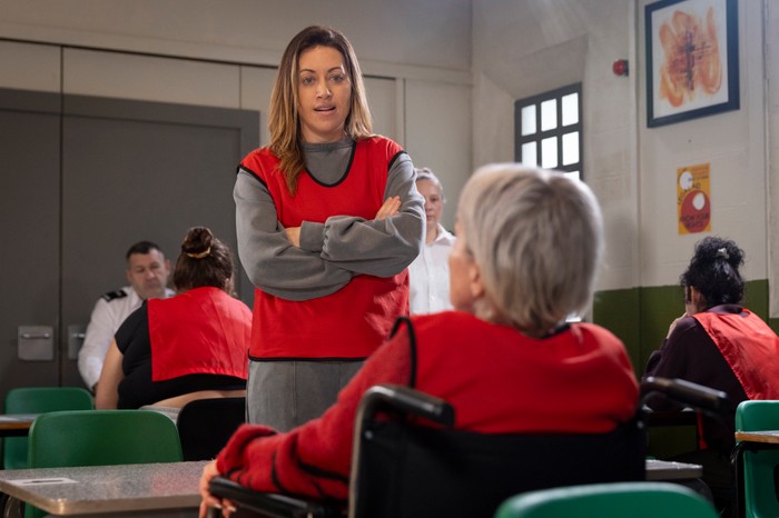Lou stands over Debbie, who is in a wheelchair, in prison in Corrie