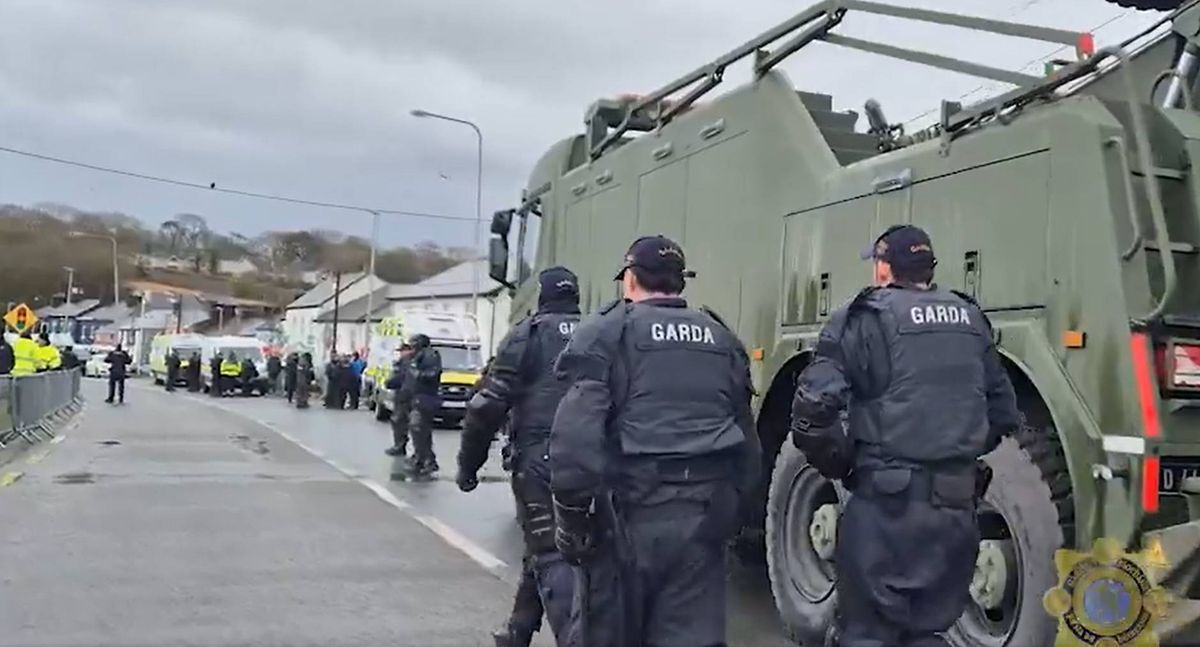 Handout video grab issued by An Garda Siochana of a Defence Forces heavy-lift recovery truck during a major operation involving scores of gardai, where large tractors that had been blocking the entrance to the Whitegate oil refinery in Co Cork were moved and fuel tankers were once again able to access the site. 