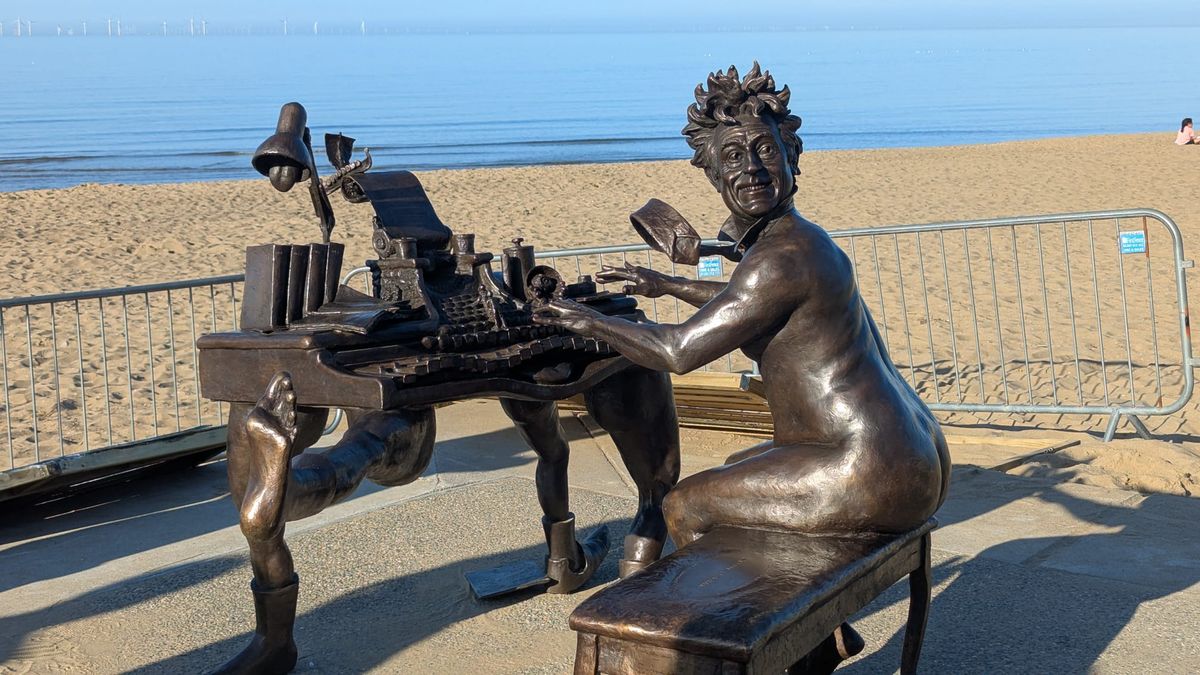 The statue of Monty Python star Terry Jones overlooking the beach at his his hometown of Colwyn Bay