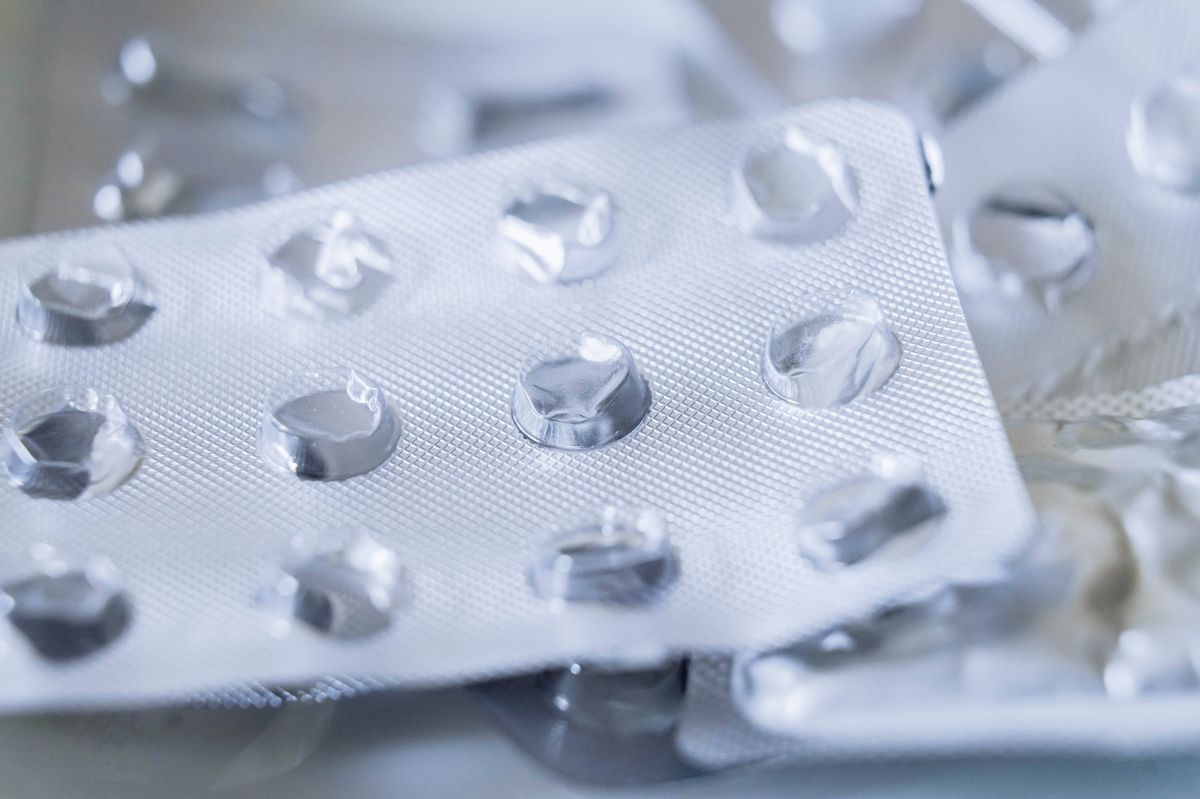 Used empty packaging from pills close up. Many different pill blister silver pharmaceutical packaging foils. Drug shortage concept.