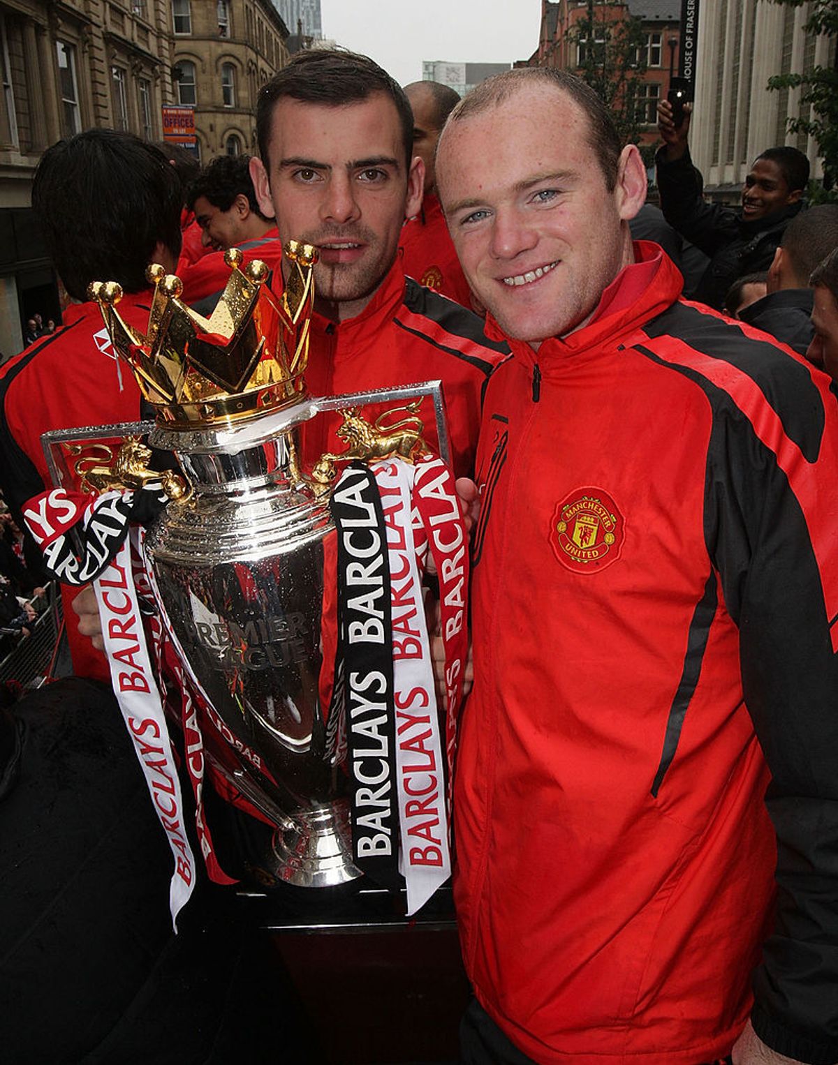 Darron Gibson (L) and Wayne Rooney of Manchester United poses with the Barclays Premier League trophy during the Manchester United Premier League Winners Parade on May 30, 2011 in Manchester, England
