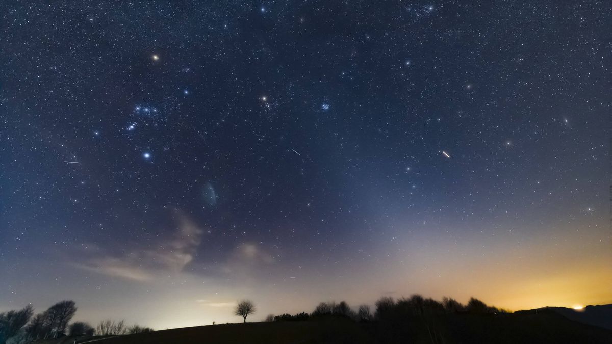 Orion constellation, zodiacal light and Milky Way stars on a dark countryside skies.