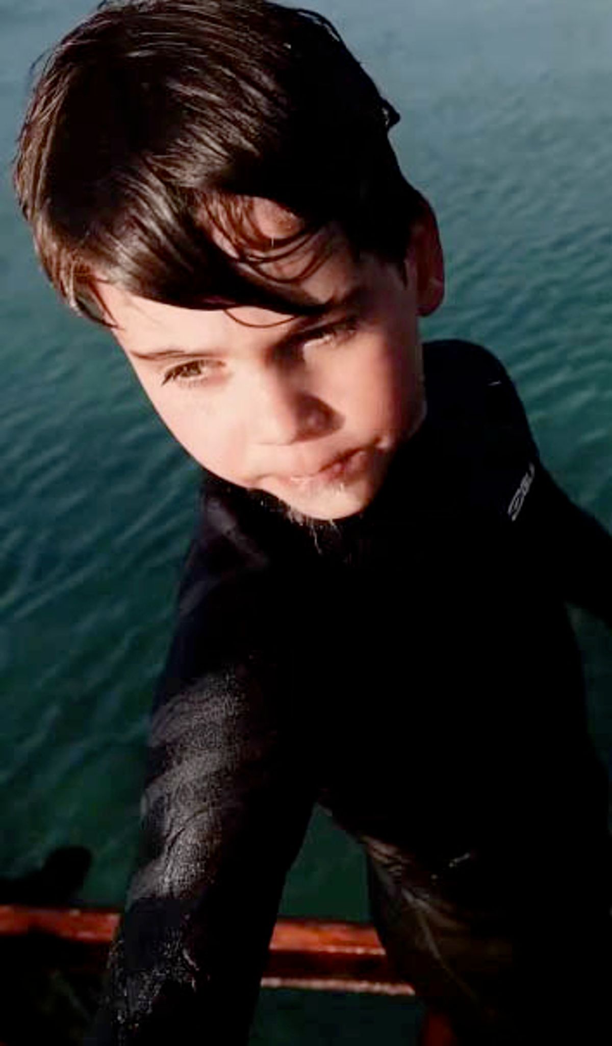 Louis in his wetsuit before jumping off a boat
