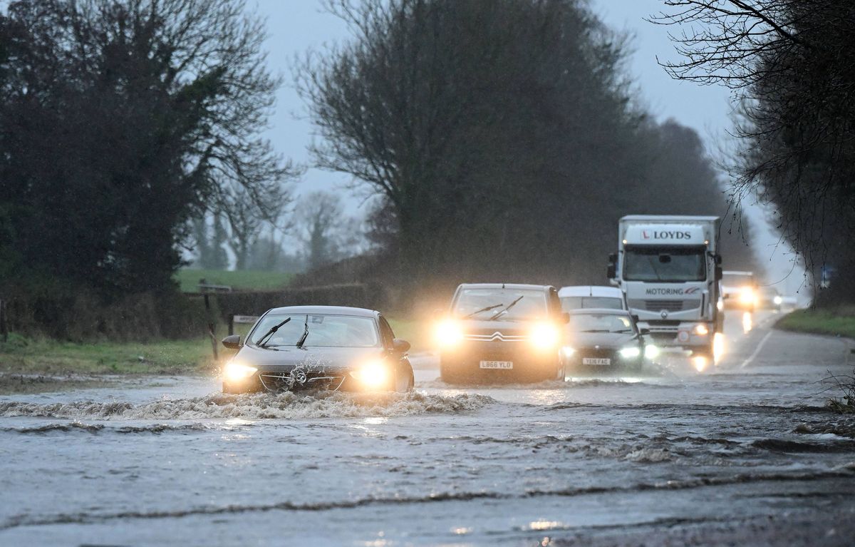 ANTRIM, NORTHERN IRELAND - JANUARY 27: Motorists contend with heavy flooding near Belfast International airport on January 27, 2026 in Antrim, Northern Ireland. Storm Chandra is causing widespread disruption across the UK and Ireland, marked by "danger to life" amber warnings for wind and rain. The storm has triggered severe flooding in the South West, particularly at the River Otter in Devon, while gusts of up to 80 mph have grounded flights in Northern Ireland and led to the closure of over 350 schools.  (Photo by Charles McQuillan/Getty Images)