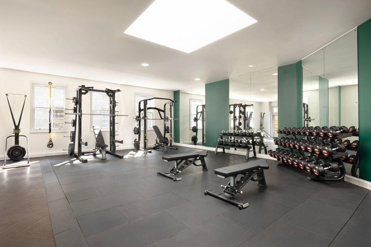 The gym area features multiple pieces of exercise equipment
