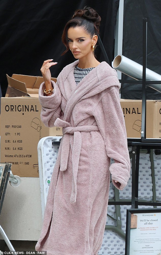 Maura accessorised with a chunky pair of gold earrings and a matching chain bracelet