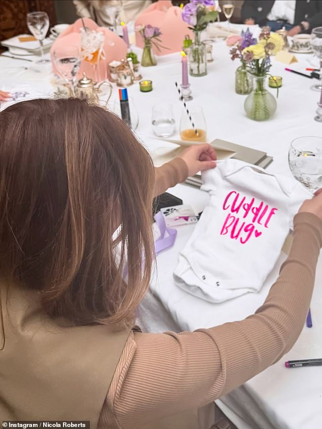 All of Nicola's guests took turns decorating their own babygrows at the shower