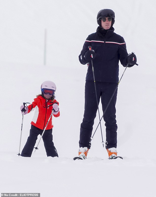 Hedge fund tycoon James Matthews encourages his daughter as the pair are seen skiing together through the French Alps