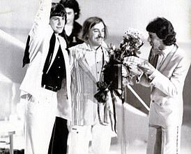 Johnny Logan (left) holds aloft the 1980 Eurovision trophy in The Hague. The song's composer, Shay Healy, is to his right