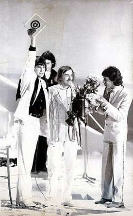 Johnny Logan (left) holds aloft the 1980 Eurovision trophy in The Hague. The song's composer, Shay Healy, is to his right